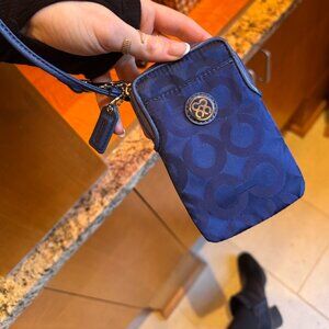 The Coach Signature Collection wallet wristlet, navy blue